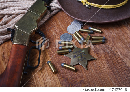 Wild west rifle, ammunition and sheriff badge Wild west rifle, ammunition and sheriff badge 47477648
