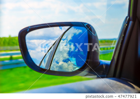 Landscape in the sideview mirror of a car 47477921