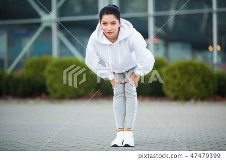 Fitness. Beautiful young woman exercising in the park - Sport and healthy lifestyle concept 47479399