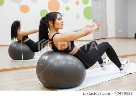 Fitness. Young woman training with Fitness Ball 47479527