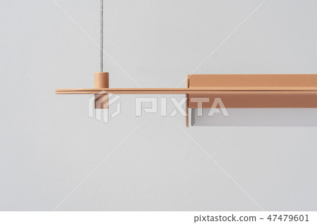 Orange metal lamp hanging on gray wall background in studio Orange metal lamp hanging on gray wall background in studio 47479601