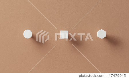 Metal white hangers in forms of circle and square and hexagon on orange wall in studio Metal white hangers in forms of circle and square and hexagon on orange wall in studio 47479945