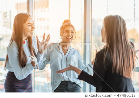 Three businesswomen working in the office. Positive workplace concept. Three businesswomen working in the office. Positive workplace concept. 47480112
