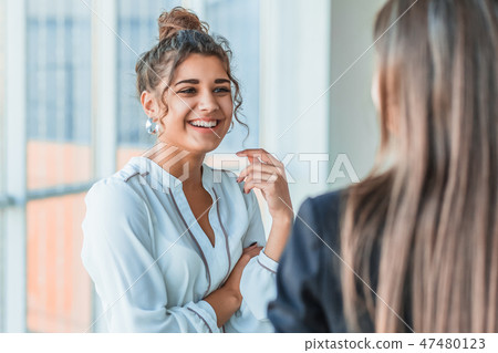 Three beautiful young business ladies. Speaks to colleagues with a copy of space on the background Three beautiful young business ladies. Speaks to colleagues with a copy of space on the background 47480123