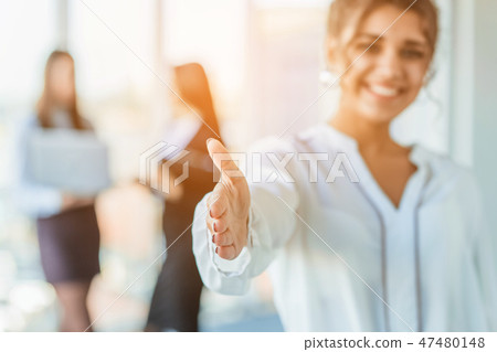 The business lady in the office giving his consent to the signing of a contract stretches out his The business lady in the office giving his consent to the signing of a contract stretches out his 47480148