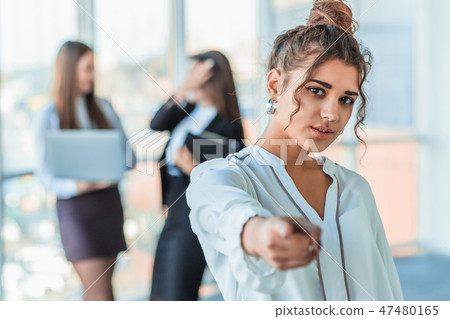 The business lady in the office giving his consent to the signing of a contract stretches out his The business lady in the office giving his consent to the signing of a contract stretches out his 47480165