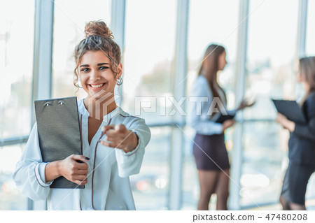 Business lady at the office talking to a smartphone. Happy smiling Caucasian business woman busy Business lady at the office talking to a smartphone. Happy smiling Caucasian business woman busy 47480208