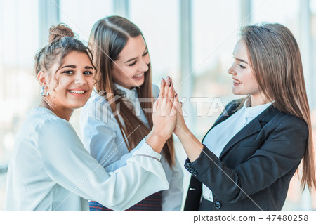 Power of friendship in business company. Three attractive happy smiling joyful smart professional Power of friendship in business company. Three attractive happy smiling joyful smart professional 47480258