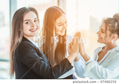 Power of friendship in business company. Three attractive happy smiling joyful smart professional Power of friendship in business company. Three attractive happy smiling joyful smart professional 47480259