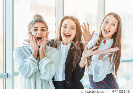 Young pretty business girls show a good gesture. Dressed in classic clothes Young pretty business girls show a good gesture. Dressed in classic clothes 47480308
