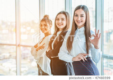 Young pretty business girls show a good gesture. Dressed in classic clothes, Young pretty business girls show a good gesture. Dressed in classic clothes, 47480399