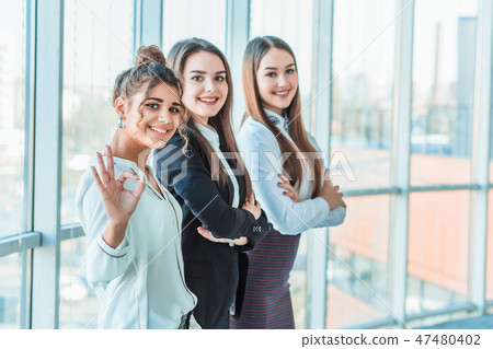 Three girl girls, demonstrating their effective integration and success in business. Three girl girls, demonstrating their effective integration and success in business. 47480402