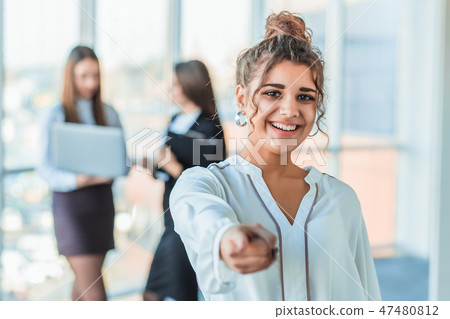 The business lady in the office giving his consent to the signing of a contract stretches out his The business lady in the office giving his consent to the signing of a contract stretches out his 47480812