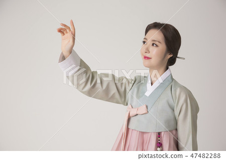 Korean beauty concept photo. Young beautiful woman wearing Hanbok, Korean traditional dress. 268 47482288