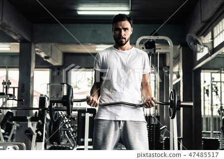 Handsome man is rowing exercise with bodybuilder Handsome man is rowing exercise with bodybuilder 47485517