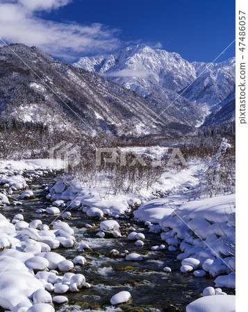 Winter mountain and Hayakatsukawa (Toyama Prefecture) Vertical Winter mountain and Hayakatsukawa (Toyama Prefecture) Vertical 47486057
