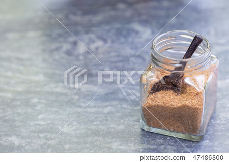 Brown sugar with wooden spoon in glass bottle. Brown sugar with wooden spoon in glass bottle. 47486800