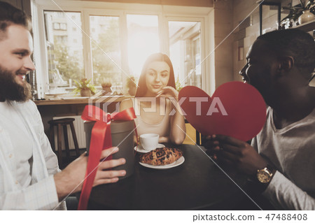 Two men congratulate young beautiful woman 47488408