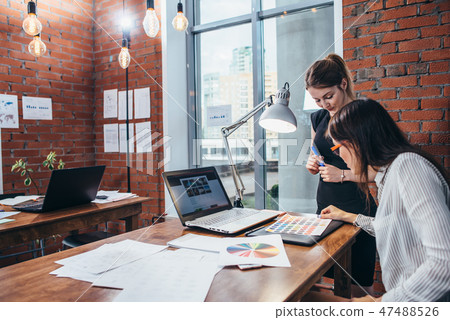 Close-up view of interior designer workspace with laptop, graphic tablet, phone and color palette on Close-up view of interior designer workspace with laptop, graphic tablet, phone and color palette on 47488526