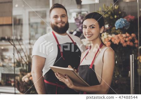 Portrait of smiling florists man and woman Portrait of smiling florists man and woman 47488544
