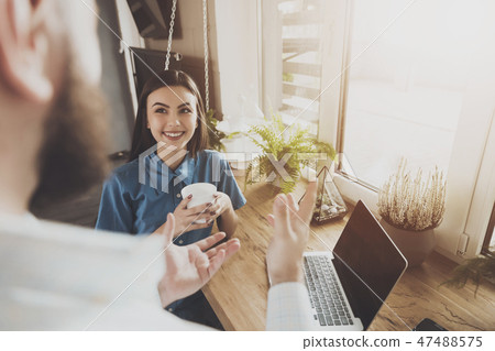 Happy young man and woman working on laptop Happy young man and woman working on laptop 47488575