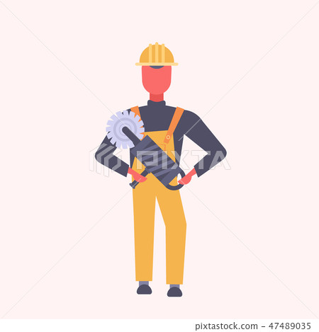 young construction worker holding handheld circular saw tradesman in yellow uniform and helmet male 47489035