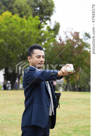 Businessman holding baseball ball Businessman holding baseball ball 47489378