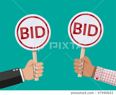 Hands holding auction paddle. 47490683