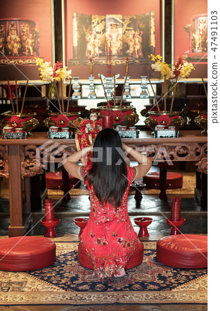 woman praying in Chinese temple woman praying in Chinese temple 47491103
