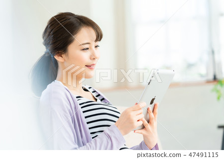 Young woman operating tablet terminal internet girls lifestyle female portrait 47491115