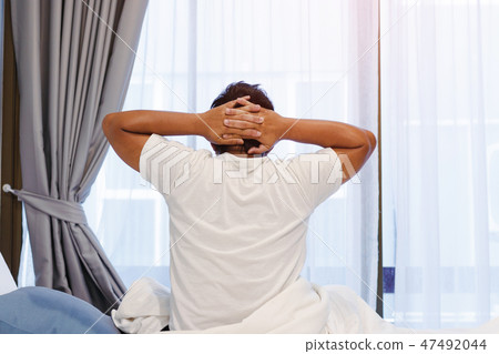 Man in bed with headache after wake up. 47492044