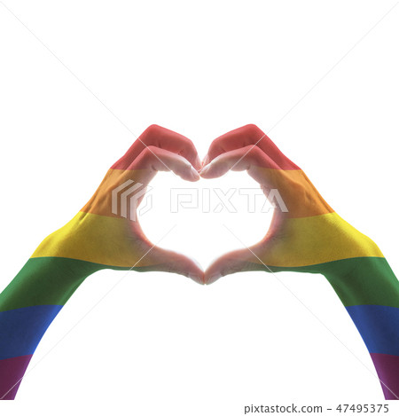 Rainbow color flag on woman hands in heart shape 47495375