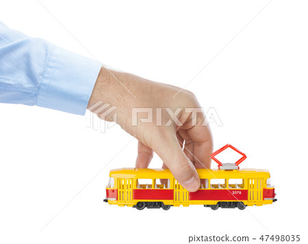 Hand with toy tram Hand with toy tram 47498035