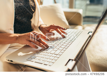 Closeup of woman hands typing on laptop keyboard Closeup of woman hands typing on laptop keyboard 47498206