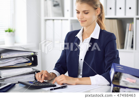 Modern business woman or confident female accountant in office. Student girl during exam preparing Modern business woman or confident female accountant in office. Student girl during exam preparing 47498463