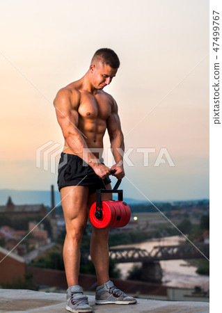 Men performing shoulder workout at rooftop Men performing shoulder workout at rooftop 47499767