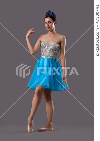 Front view of graceful ballerina looking at camera in studio Front view of graceful ballerina looking at camera in studio 47500741