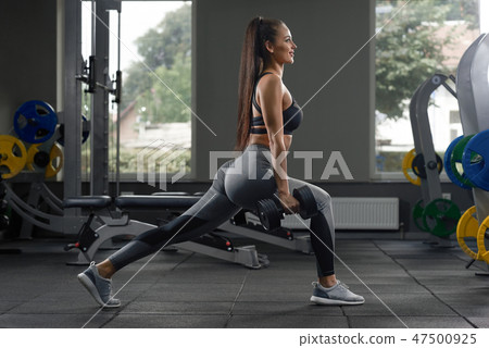 Isolated portrait of brunette doing exercises. 47500925