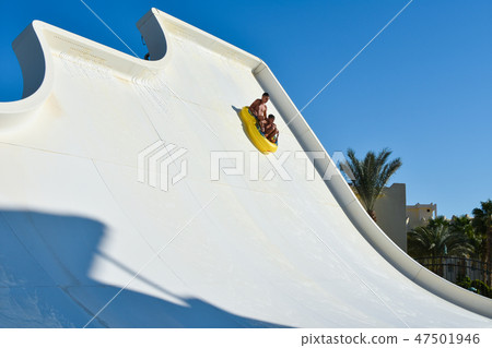 family dad and son ride tubing on water attraction 47501946