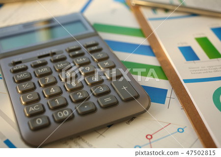 Silver calculator and financial statistics on clipboard 47502815
