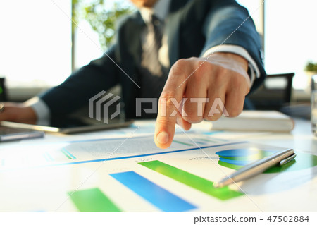 Hand of businessman in suit filling and signing with 47502884