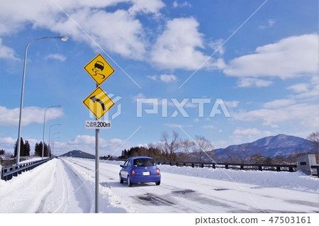 Car running on a frozen bridge on a snowy road Car running on a frozen bridge on a snowy road 47503161