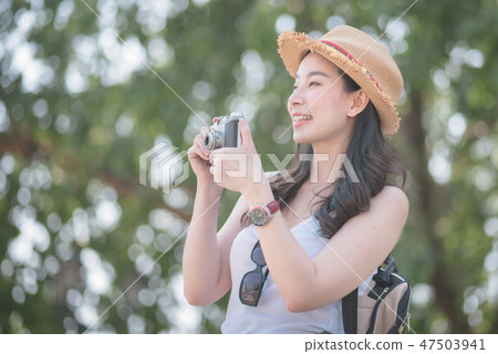 Beautiful asian tourist woman enjoy taking photo Beautiful asian tourist woman enjoy taking photo 47503941