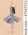 Ballerina dance in a gray dress on a beige background 47507252
