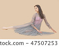 Ballerina dance in a gray dress on a beige background 47507253