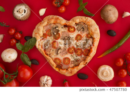 Pizza heart shaped on red Pizza heart shaped on red 47507780