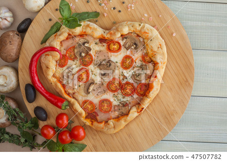 Pizza heart shaped on wood Pizza heart shaped on wood 47507782
