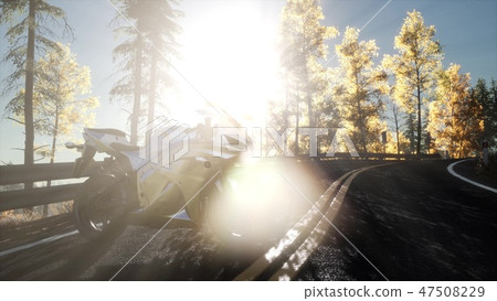 sportbike on tre road in forest with sun beams 47508229