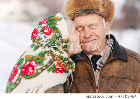 Portrait of happy senior couple. Elderly woman kiss her husband in weighty. old couple walkink in 47508464