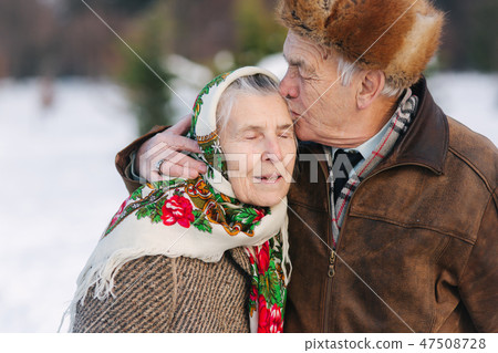 Portrait of senior couple. Elderly man kiss his wife in weighty. old couple walkink in the park in Portrait of senior couple. Elderly man kiss his wife in weighty. old couple walkink in the park in 47508728